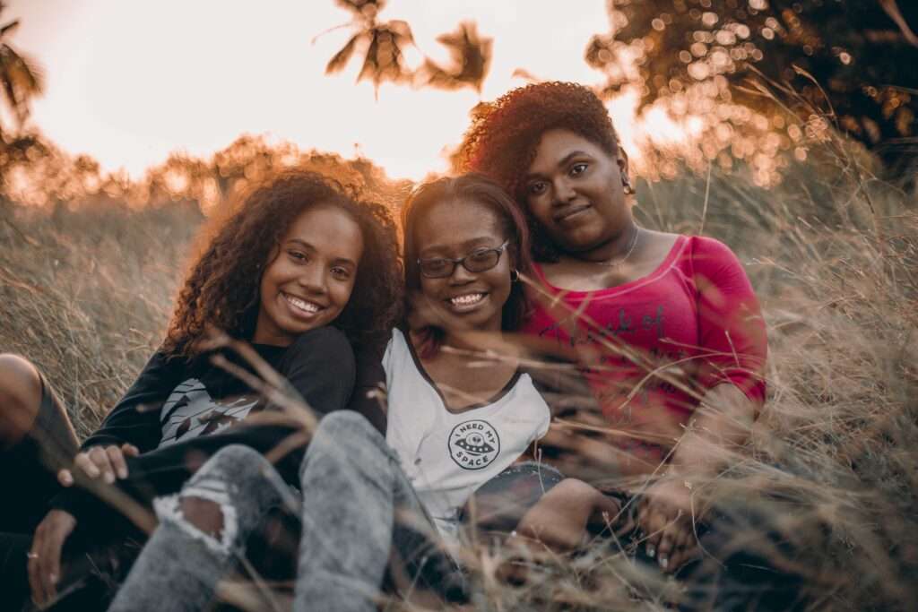 Three Women Sitting On Grass 1436618